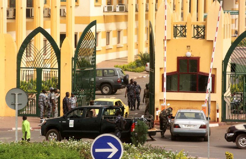 Soldiers patrol the entrance to the government ministries compound Thursday in Bamako, Mali, after the military seized power in a coup. 