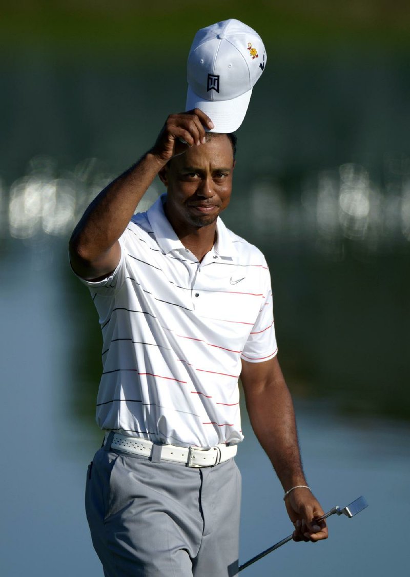 Tiger Woods acknowledges the crowd after shooting a 7-under-par 65 on Friday to gain a share of the lead with Charlie Wi at the Arnold Palmer Invitational in Orlando, Fla. 