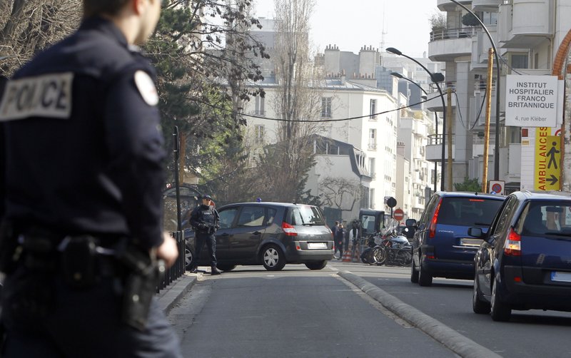 Cars with their registration plates covered with tape transfer passengers believed to be Abdelkader Merah and his companion to the French police's anti-terrorist headquarters in Levallois-Perret, outside Paris, Saturday, March 24, 2012. Merah's brother, Mohamed Merah is blamed for a series of deadly shootings which have shocked France and upended the country's presidential race. Merah, who claimed allegiance to al-Qaida, died in a hail of gunfire Thursday after a dramatic 32-hour-long standoff with law enforcement.