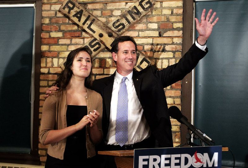 Republican presidential candidate, former Pennsylvania Sen. Rick Santorum, right, is joined by his daughter Sarah Maria during a news conference in Green Bay, Wis., Saturday, March 24, 2012. Santorum won the Louisiana Republican presidential primary Saturday, beating front-runner Mitt Romney in the race to challenge President Barack Obama. (AP Photo/Jae C. Hong)