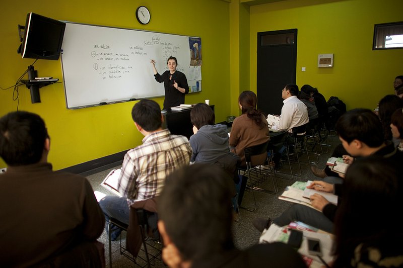 In this Sunday, Feb. 26, 2012 photo, an instructor teaches a French course in a classroom of Alliance Francaise, an organization that promotes French language and culture, in Tianjin, China. Thousands of people in China are trying to write their own ticket out of the country - in French. Chinese desperate to emigrate have discovered a backdoor into Canada that involves applying for entry into the country's francophone province of Quebec - as long as you have a good working knowledge of the local lingo. 