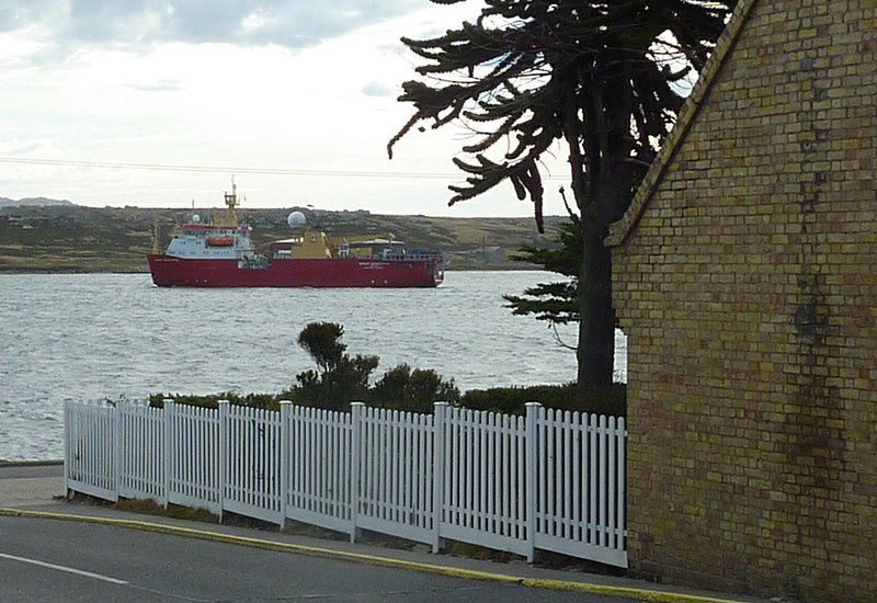 In this March 9, 2012 photo, a survey ship sails in Stanley Harbour before leaving on a scientific mission to study the undersea topography for use in offshore oil exploration, near the British Antarctic Survey base, right, in Stanley, Falkland Islands. The Falkland Islands have struck oil, potentially pumping billions of dollars into their treasury and creating an entirely unfamiliar challenge: the prospect of sudden and tremendous wealth. 
