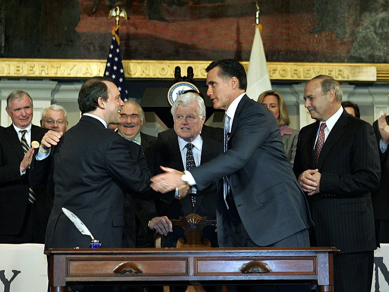 In this April 12, 2006 file photo, Massachusetts Gov. Mitt Romney, right, shakes hands with Massachusetts Health and Human Services Secretary Timothy Murphy after signing into law a landmark bill designed to guarantee that virtually all Massachusetts residents have health insurance, at Faneuil Hall in Boston, as  Sen. Edward Kennedy, D-Mass., stands at center, and Massachusetts House Speaker Salvatore DiMasi, stands at right. Former Republican presidential contender Romney says President Barack Obama's new health care bill is unconstitutional, deserves to be repealed and will help cost the Democrat a second term. 