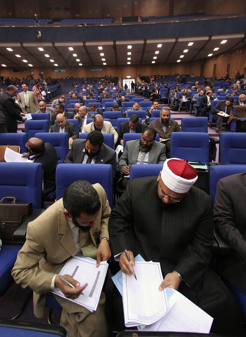 Egyptian lawmakers vote during a session to select a constitutional panel in Cairo, Egypt, Saturday, March 24, 2012. Egyptian parliamentarians on Saturday cast ballots to select a 100-member panel that will draft the country's new constitution, amid deep polarization between liberals and Islamists over the process. 