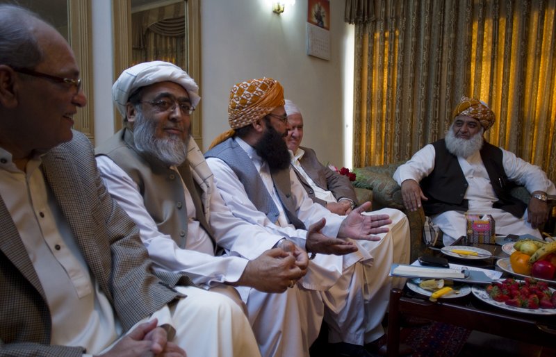 Maulana Fazal-ur-Rehman, right, chief of Pakistani religious party Jamiat Ulema-e-Islam, heads a meeting of opposition leaders on Saturday, March 24, 2012, to discuss a strategy for the forthcoming Parliament session scheduled to debate the terms of re-engagement with United States, in Islamabad, Pakistan. The main issue of the agenda is restoration of the NATO supply to neighboring Afghanistan, which which was suspended after NATO airstrikes that killed 24 Pakistani soldiers.