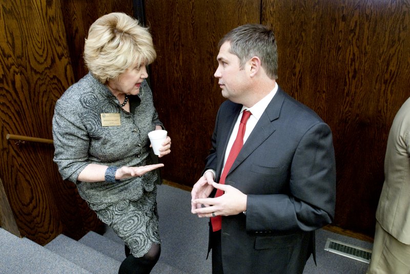 Brenda Gullett, a member of the state board of education talks to Matt McClure, superintendent of the Cross Co., school district January 9, 2012. The state Board of Education approved four schools whose school districts wish to convert into charter schools.