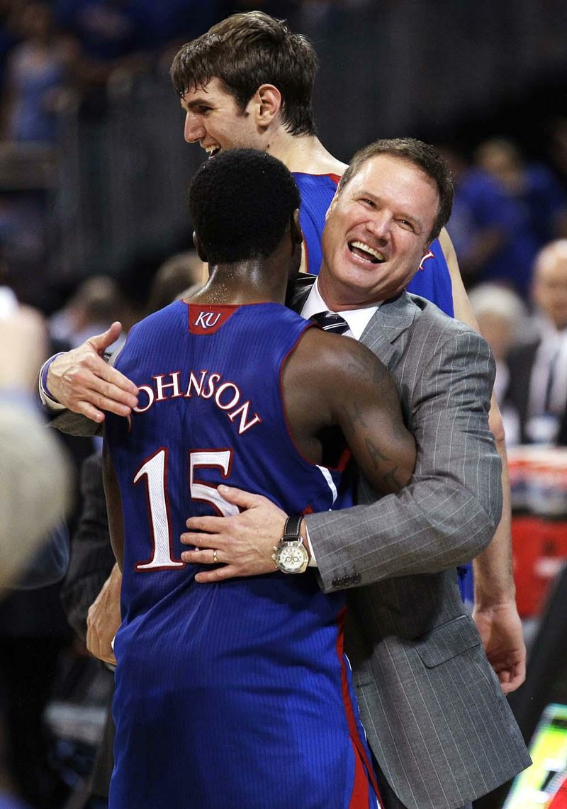 Kansas Coach Bill Self (right) embraces Elijah Johnson after the Jayhawks beat North Carolina 80-67 in St. Louis on Sunday to win the Midwest Regional and a trip to the Final Four. 