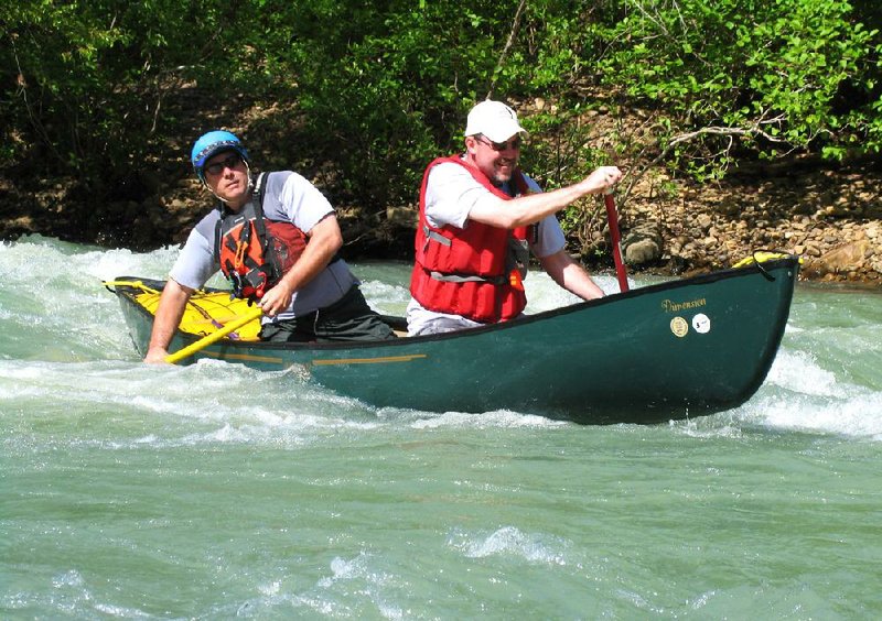 Instructors Tom Kennon (left) and Mike Peerson had fun in 2008 showing off their skill in the “Whoop and Holler” rapid on the Mulberry River during the Arkansas Canoe Club’s annual School of Whitewater Paddling. 