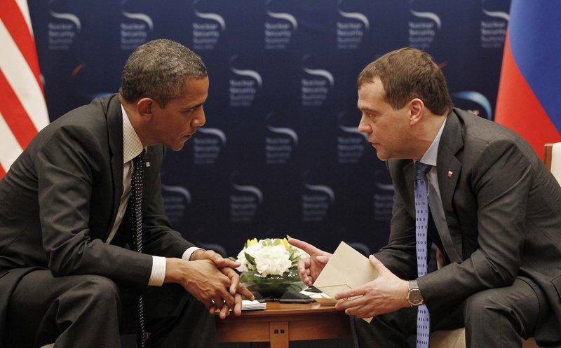 U.S. President Barack Obama, left, and Russian President Dmitry Medvedev chat during a bilateral meeting at the Nuclear Security Summit in Seoul, South Korea, Monday, March, 26, 2012. 