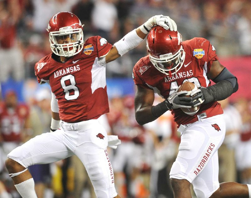 Arkansas senior Tenarius Wright (right) shifted from defensive end to inside linebacker during the Razorbacks’ last spring practice. Wright played linebacker at Memphis Whitehaven High School. 