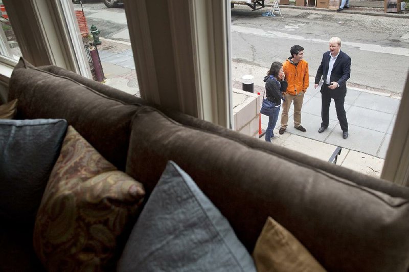 Realtor Lindsay Reihman (right) talks to potential homebuyers Chris Porter and Beth Purvis at the Ontario Road Flats condominiums Sunday in Washington, D.C. 