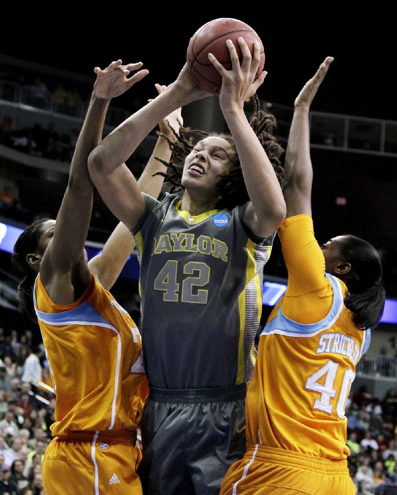 Baylor post player Brittney Griner (center) goes up for a shot between Tennessee’s Vicki Baugh (left) and Shekinna Stricklen (Morrilton) during the first half of Monday’s regional final in Des Moines, Iowa. 