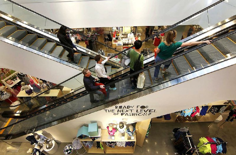 Shoppers ride the escalator in a Hennes & Mauritz AB (H&M) store at the City Creek Center in Salt Lake City, Utah, U.S., on Thursday, March 22, 2012. The New York-based Conference Board is scheduled to release consumer confidence data on March 27. Photographer: George Frey/Bloomberg