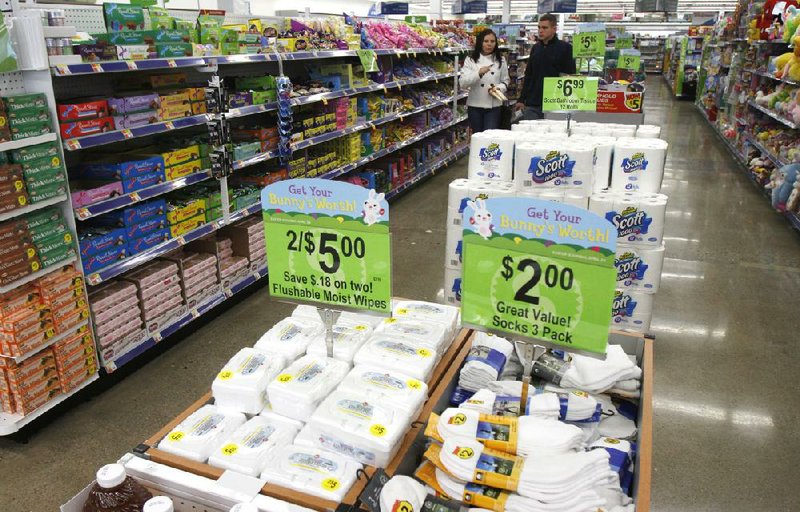 In a Monday, March 21, 2011 photo, shoppers walk in the aisle at Walgreens, in Burlington, Vt. Drugstore operator Walgreen Co. says its fiscal second-quarter earnings fell almost 8 percent due in part to its decision to leave the Express Scripts pharmacy network and a slow flu season.  (AP Photo/Toby Talbot)