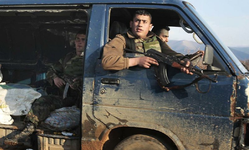 Lebanese army soldiers sit inside a confiscated van that is believed to be carrying ammunition captured by Lebanese troops during a raid, at the Lebanese-Syrian border town of Qaa, in northeastern Lebanon, Tuesday, March 27, 2012. Syria has accepted a peace plan by U.N. envoy Kofi Annan that includes a government cease-fire, but the bloodshed persisted Tuesday as intense clashes between soldiers and rebels spilled across the border into Lebanon, officials said. (AP Photo/Hussein Malla)