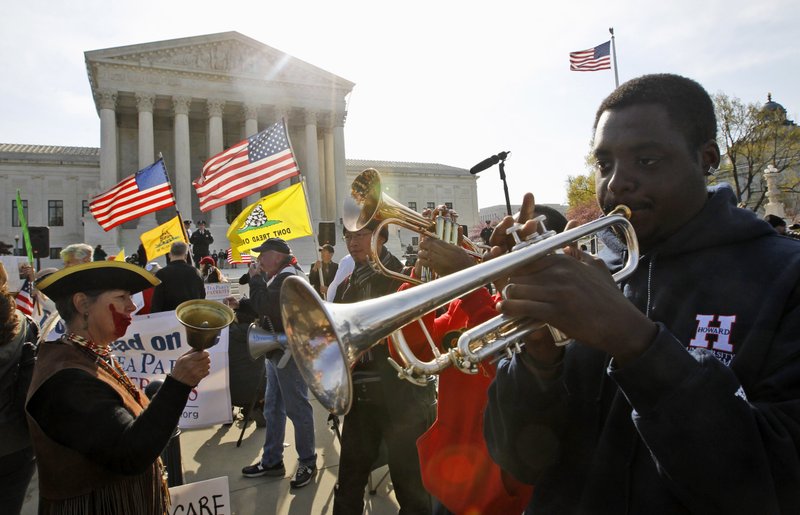Jonathan Neal, a senior at Howard University, plays his trumpet in front of the Supreme Court in Washington, on Wednesday, March 28, 2012, on the final day of arguments regarding the health care law signed by President Barack Obama.