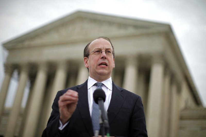 Paul Clement, attorney for the 26 states challenging the 2010 health-care law, speaks Wednesday outside the Supreme Court after the end of arguments before the court. 