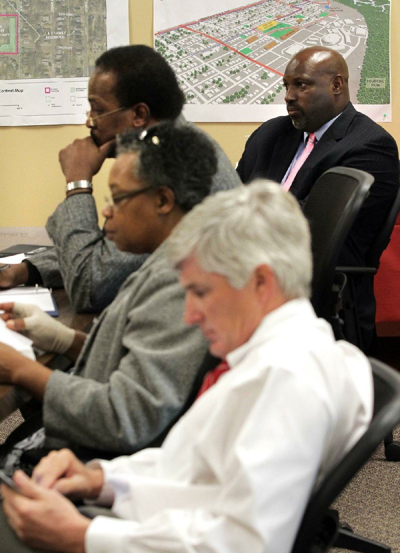 Former Little Rock Housing Authority board member Robert Webb (back right) sits in on a board meeting Wednesday. Webb said he was not reappointed after opposing Little Rock’s sales-tax increase. 