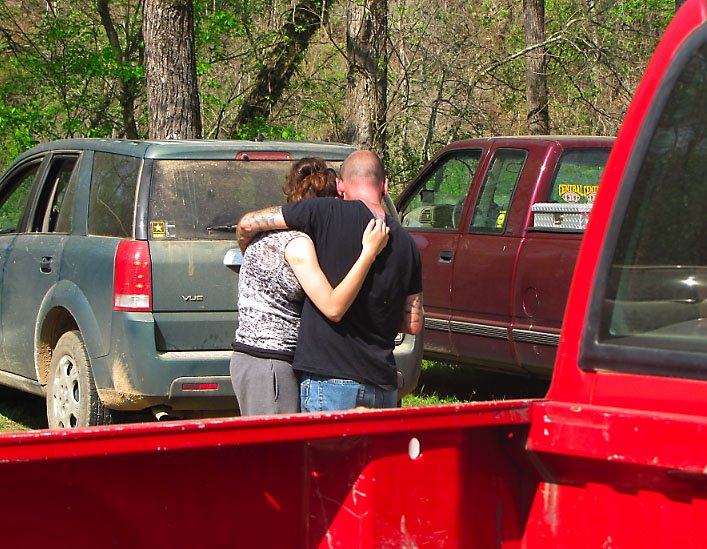 Caleb's mother and stepfather, Amanda and Randy Muir, embrace shortly after Caleb's body is discovered.