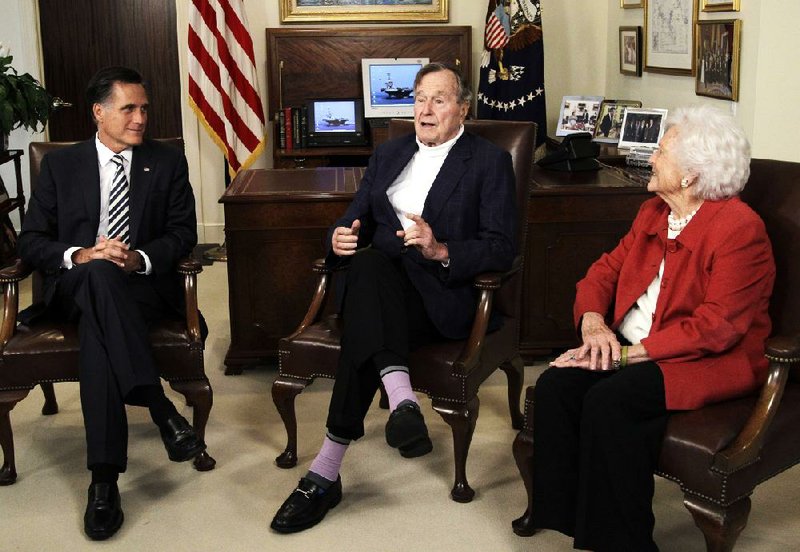 Republican presidential candidate and former Massachusetts Gov. Mitt Romney (left) meets with former President George H.W. Bush and Barbara Bush to receive their endorsements Thursday in Houston. 