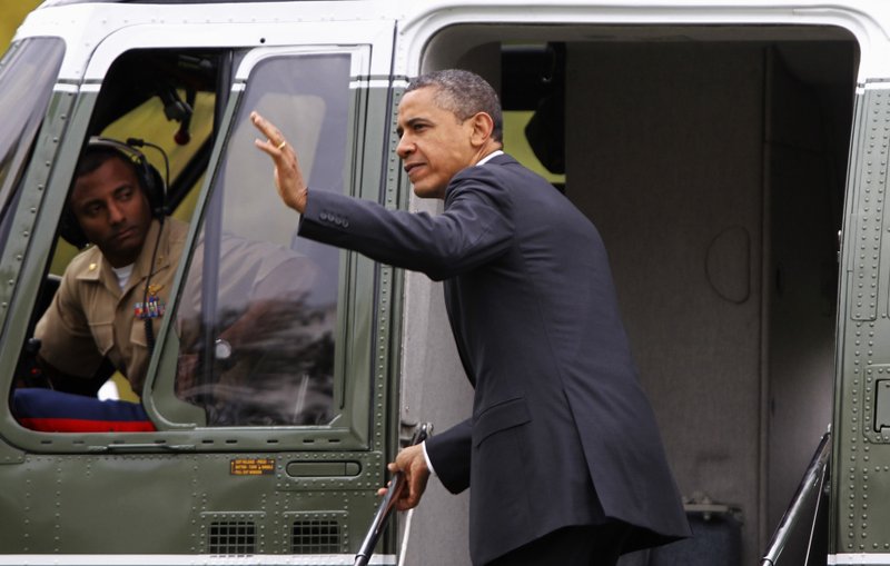 President Barack Obama waves as he boards Marine One helicopter on the South Lawn of the White House in Washington, Friday, March 30, 2012, as he travels to Vermont and Maine. 