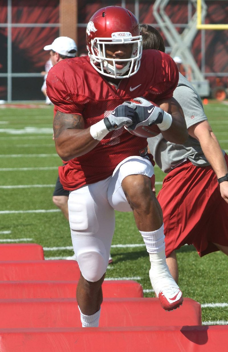 Arkansas running back Knile Davis went through drills Friday, but did not take part in Friday’s live scrimmage. 
