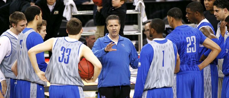 Coach John Calipari (middle) talks to his team during Friday’s practice at the Superdome in New Orleans. The Wildcats hold a 29-14 series lead over Louisville, including a 69-62 victory earlier this season. 