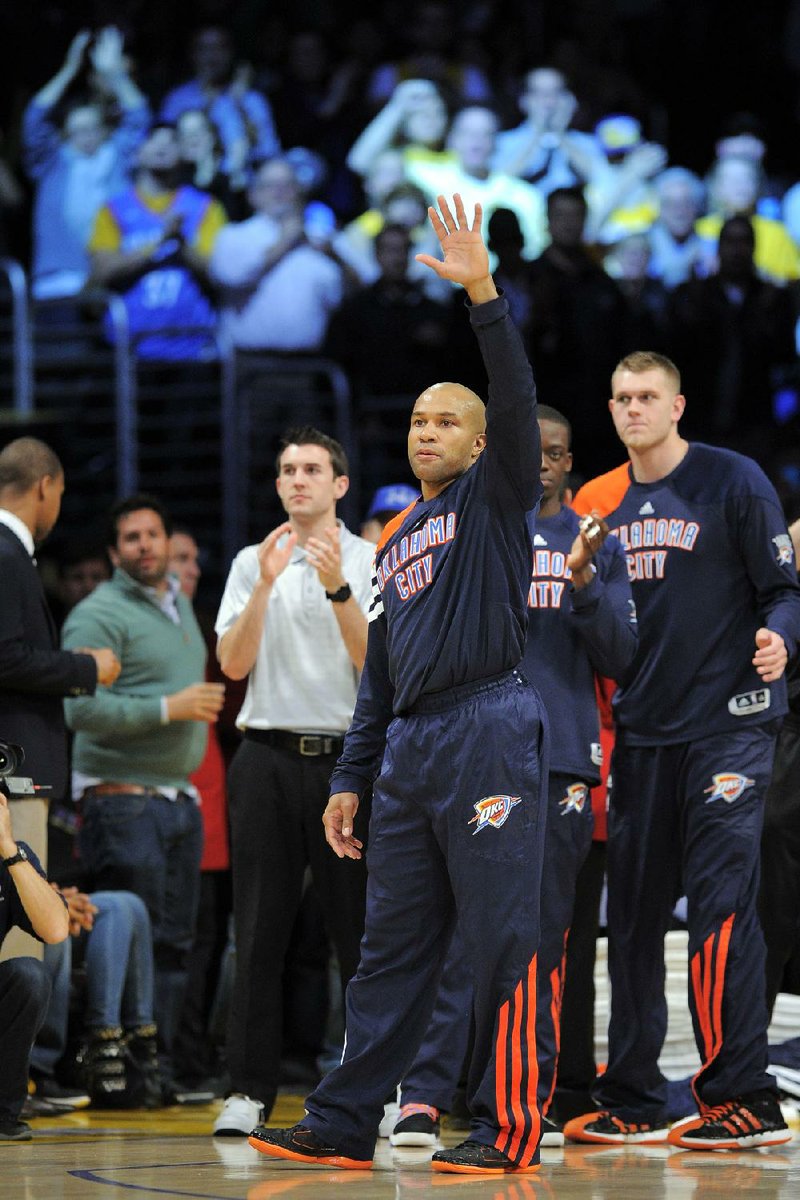 Oklahoma City guard Derek Fisher waves to the crowd Thursday night before the Thunder’s victory over the Los Angeles Lakers. It was Fisher’s first game in Los Angeles since being traded by the Lakers earlier this month. 