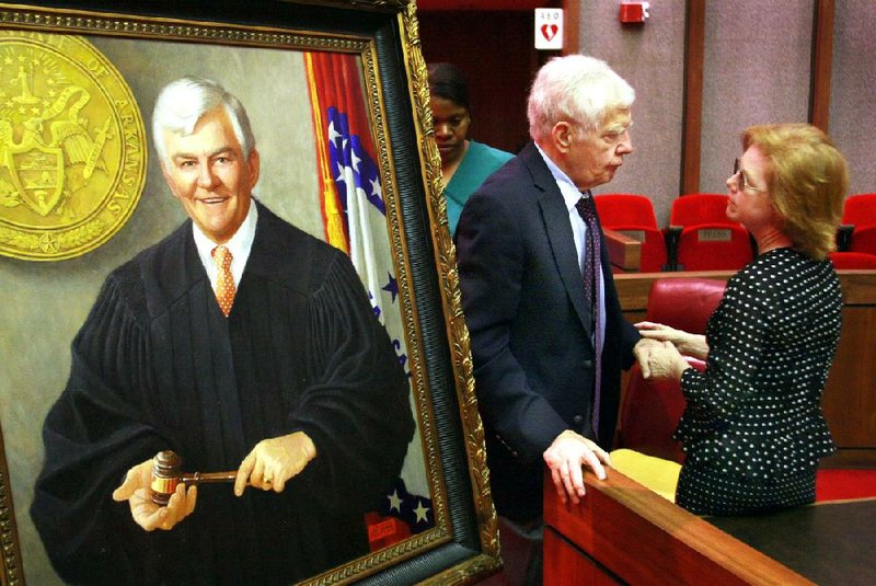 Retired Supreme Court Justice Tom Glaze and his wife, Phyllis, attended the unveiling of his official portrait in the Supreme Court courtroom in Little Rock last June. Glaze died Friday in North Little Rock. He was 74. 