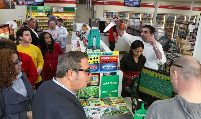 Kinju Patel and her husband, Kinjal Patel, owners of the 7-11 store in Northfield, N.J., sell lottery tickets for Mega Millions as a line forms in the store Friday, March 30, 2012. Across the country, Americans plunked down an estimated $1.5 billion on the longest of long shots: an infinitesimally small chance to win what could end up being the single biggest lottery payout the world has ever seen.