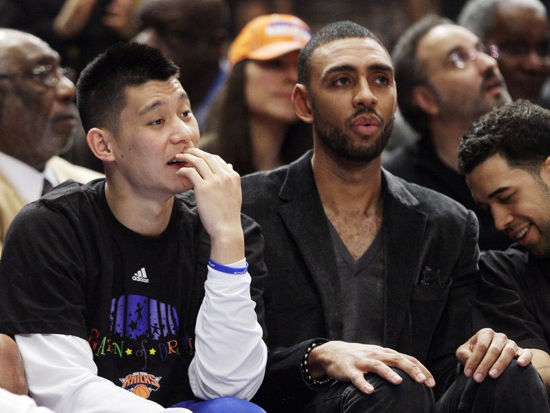 New York Knicks' Jeremy Lin, left, Jared Jeffries, center, and Landry Fields, right, watch from the bench during the second half of an NBA basketball game against the Cleveland Cavaliers, Saturday, March 31, 2012, in New York. The Knicks won 91-75. Lin will miss the rest of the regular season because he needs knee surgery that will sideline him six weeks and could leave the Knicks without their star point guard in the playoffs _ if they make it that far. 