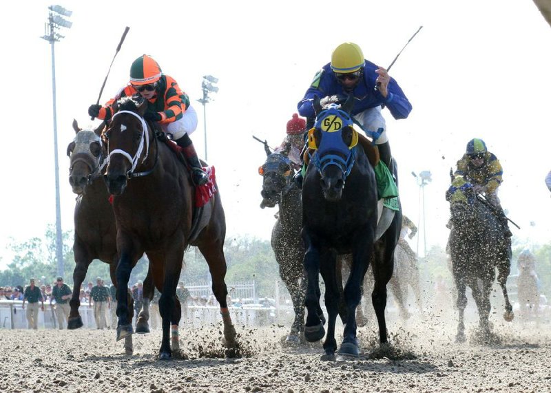 Hero of Order (right) with Eddie Martin Jr., fends off a late-charging Mark Valeski, with jockey Rosie Napravnik (right) to win the $1 million Louisiana Derby Sunday at Fair Grounds in New Orleans. Hero of Order, sent off at odds of 109-1, paid $220.80 to win. 