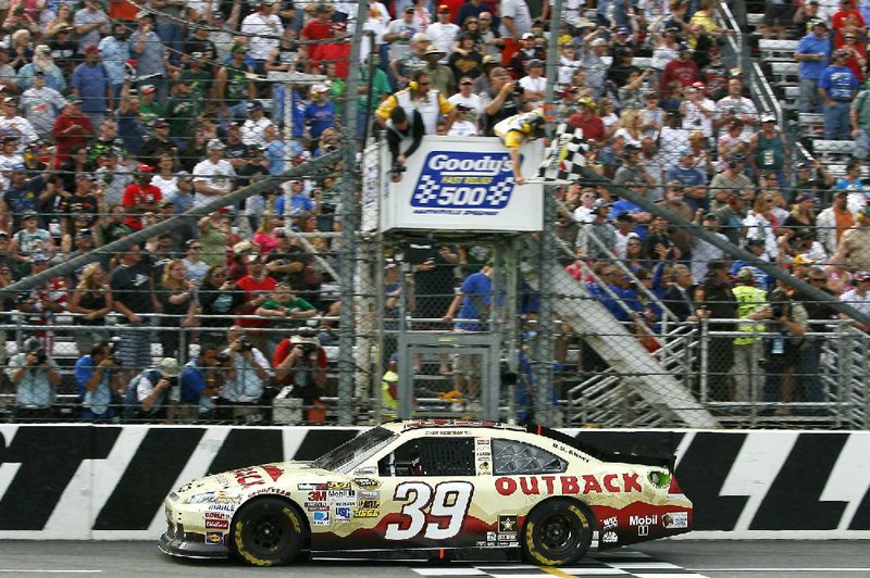 Ryan Newman (39) takes the checkered flag, signifying victory in the Goody’s Fast Relief 500 at Martinsville Speedway in Martinsville, Va., Sunday. 