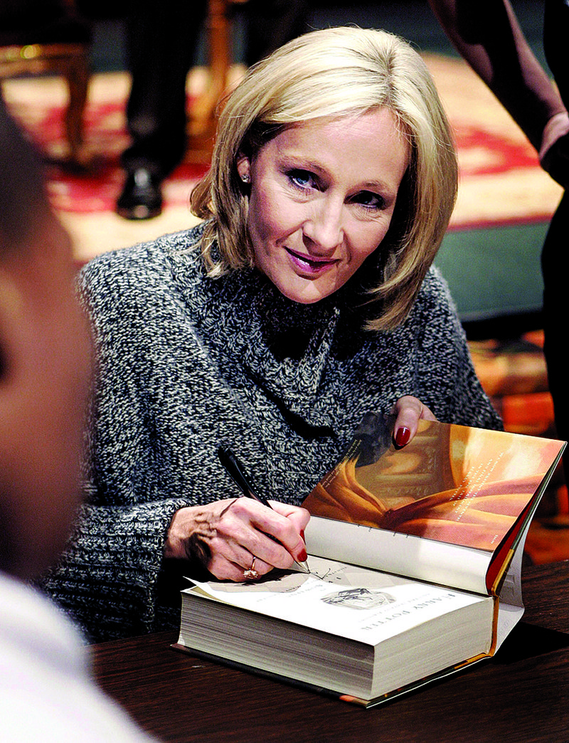 Author J.K. Rowling signs a copy of her book Harry Potter and the Deathly Hallows in New Orleans in 2007. 