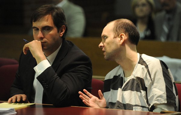 Zachariah Scott Marcyniuk, right, speaks with Toney Brasuell, one of his legal team, on Wednesday in Judge William Storey’s courtroom in Fayetteville. Marcyniuk is appealing his conviction of breaking into the home of Kate Wood and murdering her in 2008.