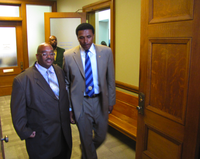 Former Rep. Fred Smith, right, leaves court after a hearing over his eligibility to run in the upcoming Democratic primary.