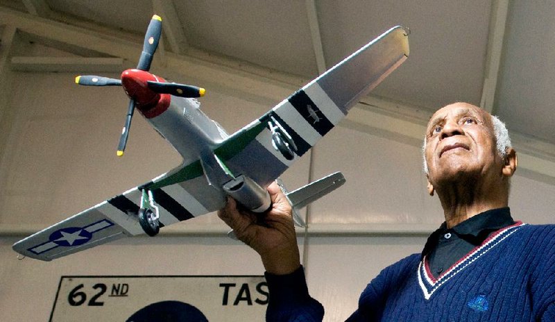 Little Rock's own Tuskegee Airman, Milton Crenchaw, in 2012.  He is holding a model of the type of airplane he flew in WWII.