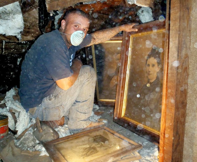 Timothy McDaniel was removing insulation in an attic crawl space behind a knee wall in Estevan Hall in Helena-West Helena when he discovered five framed portraits and photos, believed to be of the antebellum home’s former residents. 