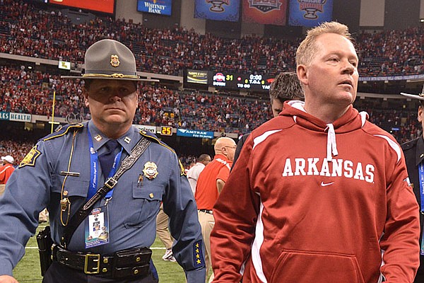 Petrino and King leave the field after the Razorback loss in the Allstate Sugar Bowl in New Orleans on January 4, 2011. The Razorbacks won the Cotton Bowl earlier this year and finished 11-2.