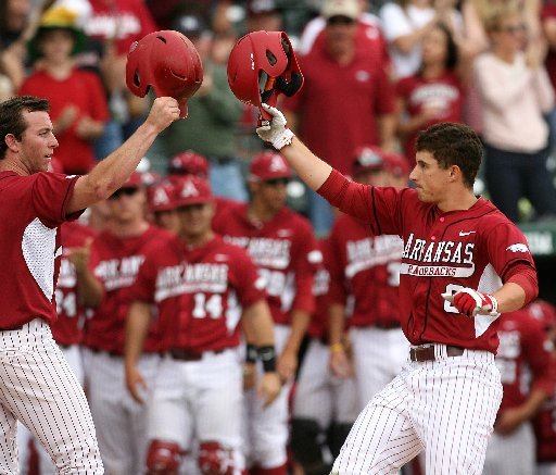 Arkansas Democrat-Gazette/WILLIAM MOORE -- Arkansas' Jimmy Bosco (right) is greeted at home by teammate Tim Carver after driving him home with a grand slam against Georgia on Saturday, March 7, 2012 at Baum Stadium in Fayetteville.