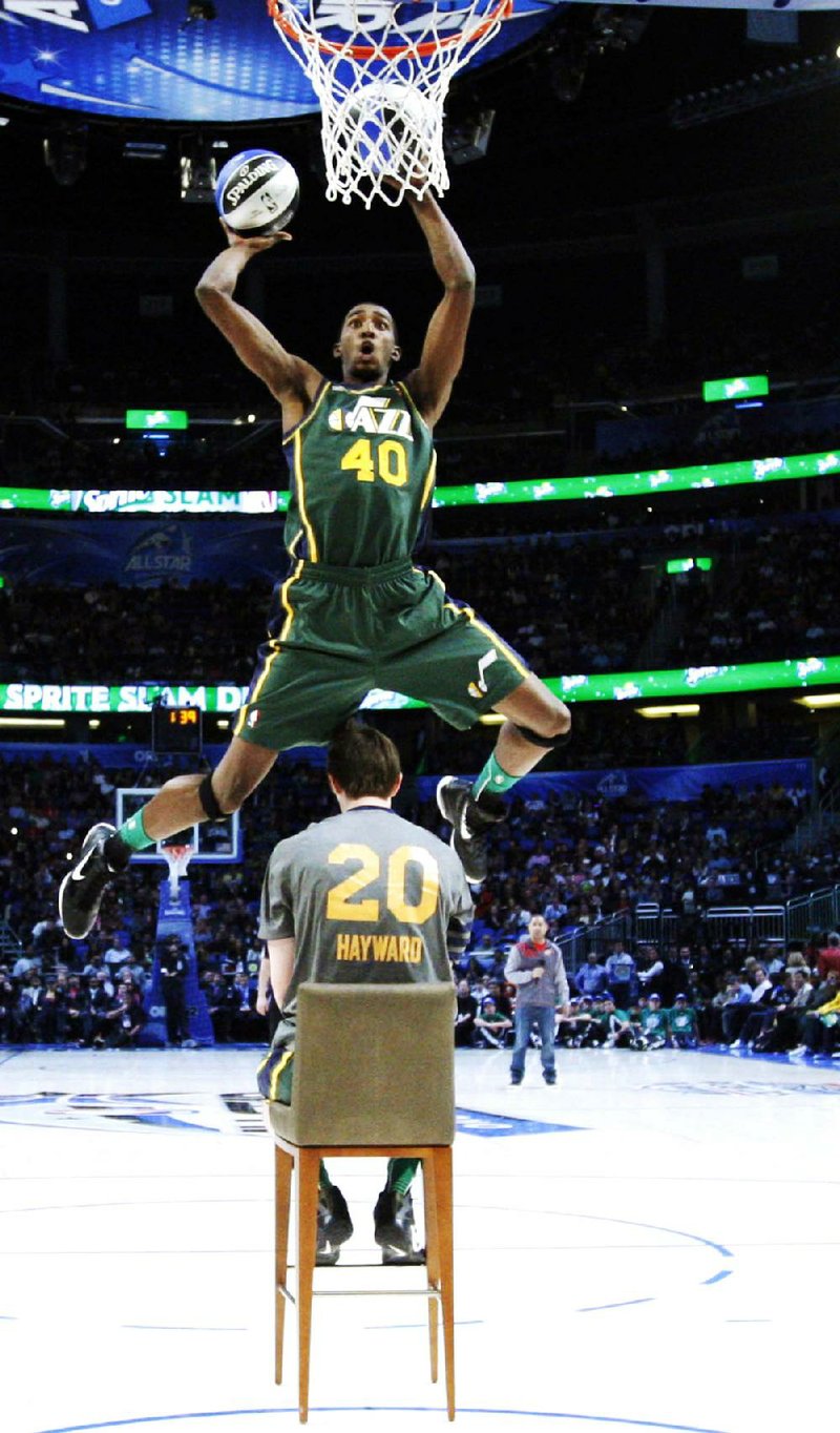 Utah Jazz’s Jeremy Evans jumps over teammate Gordon Hayward on Feb. 25 during the NBA basketball All-Star Slam Dunk Contest in Orlando, Fla. 