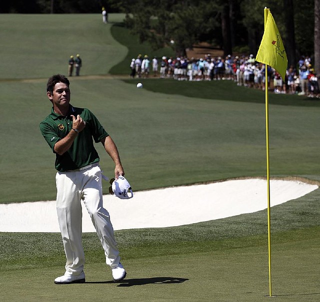 Louis Oosthuizen throws his ball to a spectator after hitting a double eagle 2 on the par-5 second hole during the final round of the Masters on Sunday. The spectator who caught the ball, Wayne Mitchell, gave it to Augusta National officials after being approached by them. 