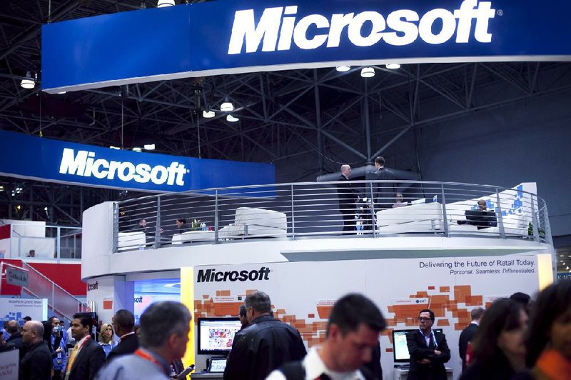 Attendees at the National Retail Federation’s convention visit the Microsoft display in this January photo. AOL Inc. shares surged Monday after it said it has agreed to sell 800 patents to Microsoft. Corp. 