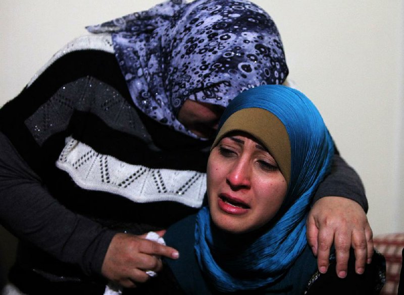 The sister (right) and another relative mourn for Ali Shaaban at their home in Beirut, Lebanon, on Monday. Shaaban, a television cameraman working for Al-Jadeed TV was shot and killed Monday on the Lebanon-Syria border. 