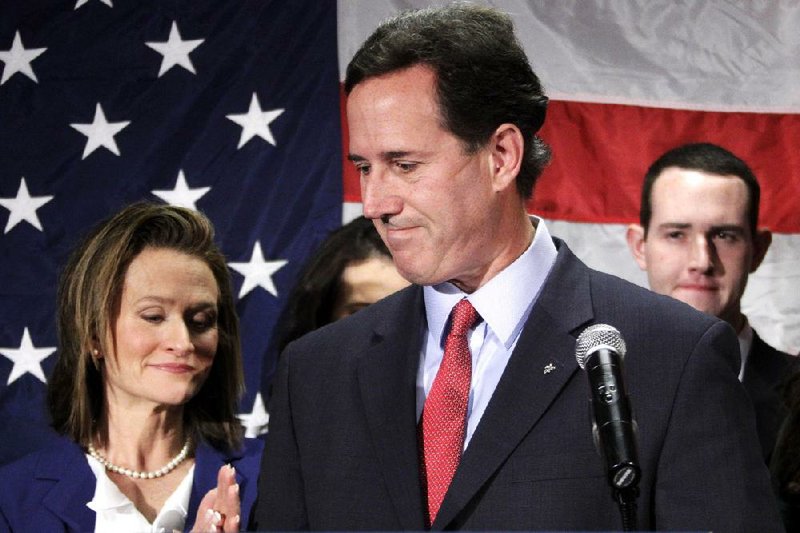 Rick Santorum turns to his wife, Karen, after announcing Tuesday in Gettysburg, Pa., that he is suspending his candidacy for the Republican nomination. 