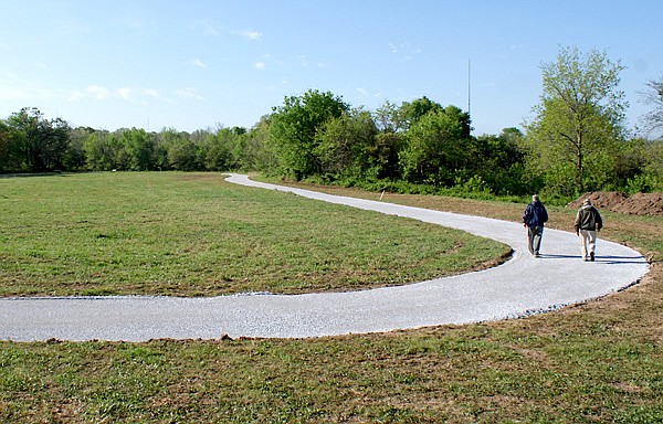 These two Gravette walkers, Al Dunagin and John Richard Meade, tried out the new portion of the walking trail at Pop Allum Park in Gravette last week. The entire trail will be handicap friendly with a smooth asphalt surface and an access ramp at the trail-head. The new surface joins an older trail which is also being paved.
