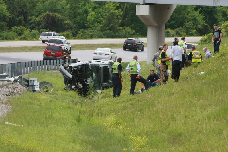 North Little Rock firefighters render aid to three people who were injured in an accident on US Hwy 67/167 soutbound at I-40 westbound in North Little Rock Wednesday afternoon.