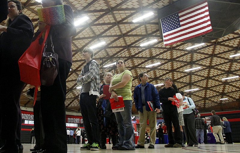 People wait in a line at a job fair Tuesday, April 10, 2012, in Gresham, Ore. Employers posted slightly more job openings and stepped up overall hiring in February. The figures suggest that modest job gains may continue in the coming months. 