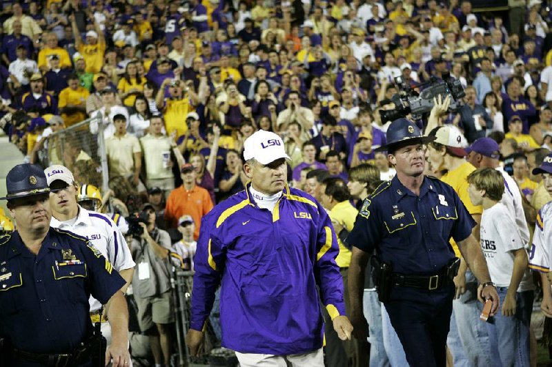 Louisiana State Police have been handling security on a volunteer basis for an LSU football coach since the late 1970s. 