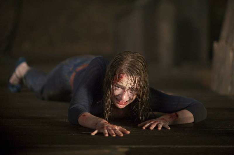 Dana (Kristen Connolly) tries to escape the inevitable tug of evil in the meta-horror movie The Cabin in the Woods. 